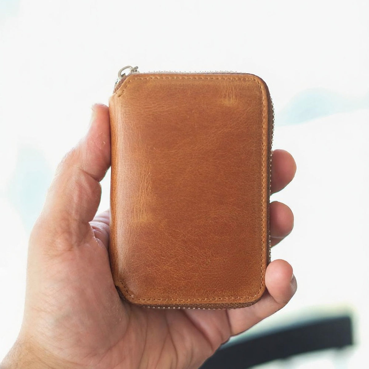Vanguard handcrafted leather zippered wallet open in hand showing card slots and mesh ID window - Yubello
