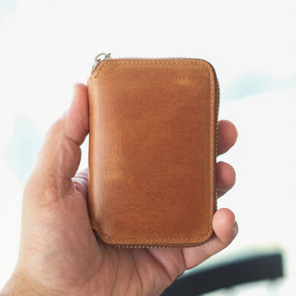 Vanguard handcrafted leather zippered wallet open in hand showing card slots and mesh ID window - Yubello