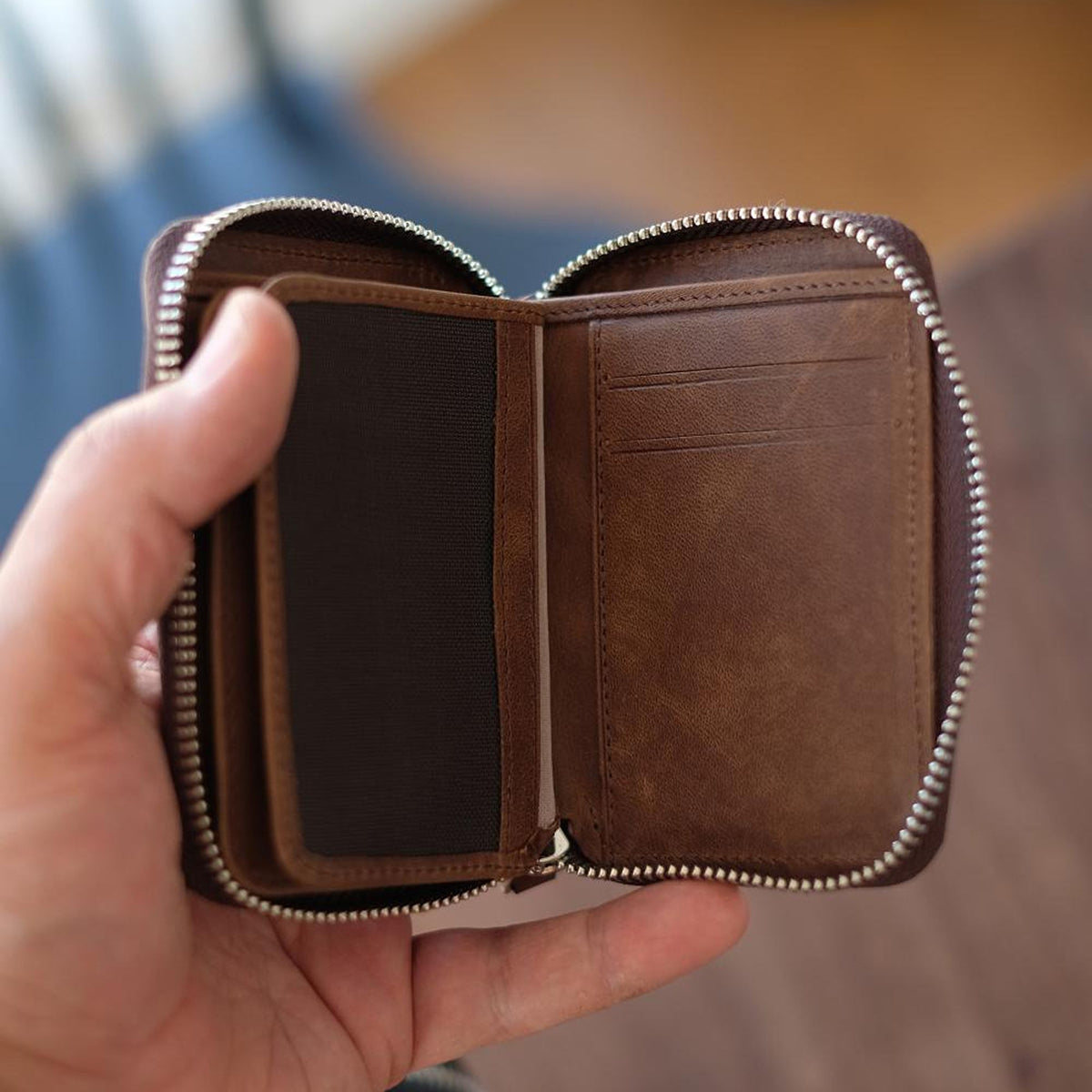 Vanguard handcrafted leather zippered wallet open in hand showing card slots and mesh ID window - Yubello