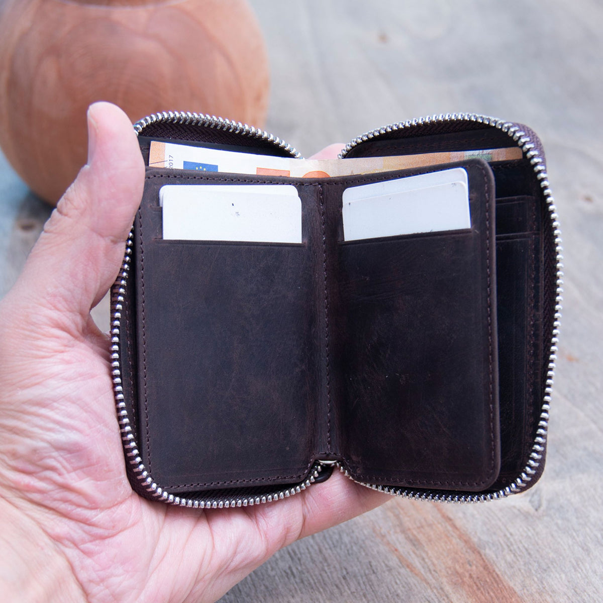Vanguard handcrafted leather zippered wallet open in hand showing card slots and mesh ID window - Yubello