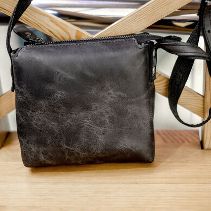 Corven handcrafted black Crazy Horse leather vertical crossbody messenger bag front view - Yubello