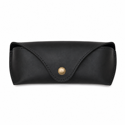 Lucent handcrafted dark black Crazy Horse leather sunglasses case with snap closure and aviator glasses on desk - Yubello