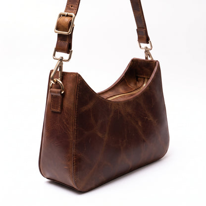 Norelle handcrafted brown Crazy Horse leather crescent shoulder bag front view - Yubello