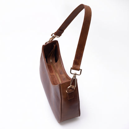 Norelle handcrafted brown Crazy Horse leather crescent shoulder bag front view - Yubello