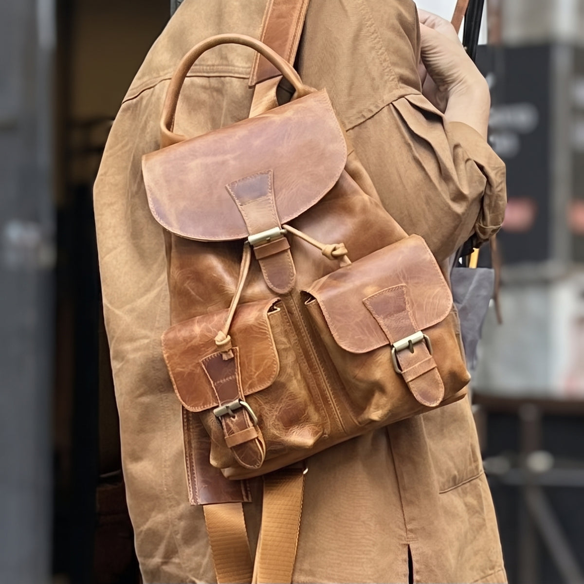 Soline handcrafted tan leather backpack vintage rucksack street style on model - Yubello