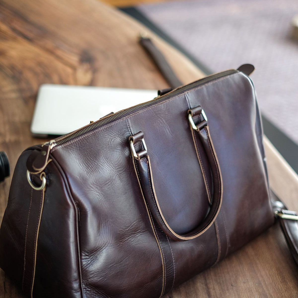 Vespera handcrafted chestnut leather travel duffle bag weekender side view - Yubello